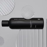Hair Luxious Repair & Moisture Conditioner bottle lying on a grey background