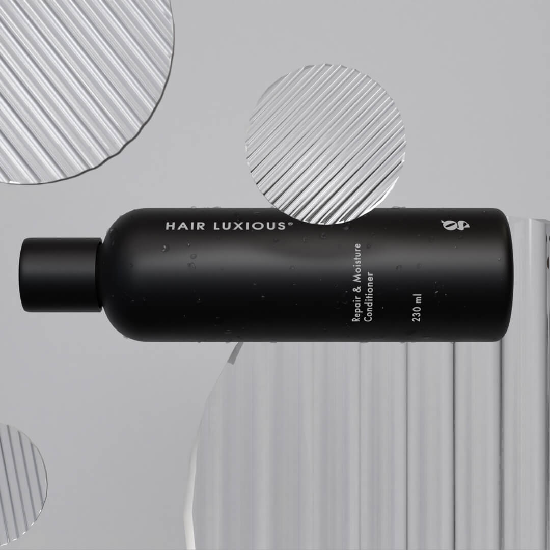 Hair Luxious Repair & Moisture Conditioner bottle lying on a grey background