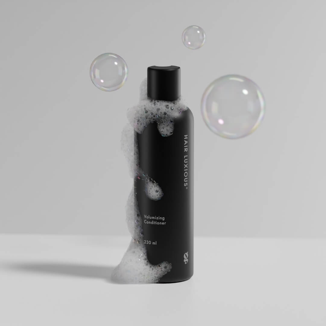 Hair Luxious Volumizing Conditioner bottle with soap bubbles