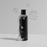 Hair Luxious Volumizing Conditioner bottle with soap bubbles