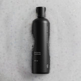 Hair Luxious Volumizing Conditioner bottle photographed flat on a stone surface