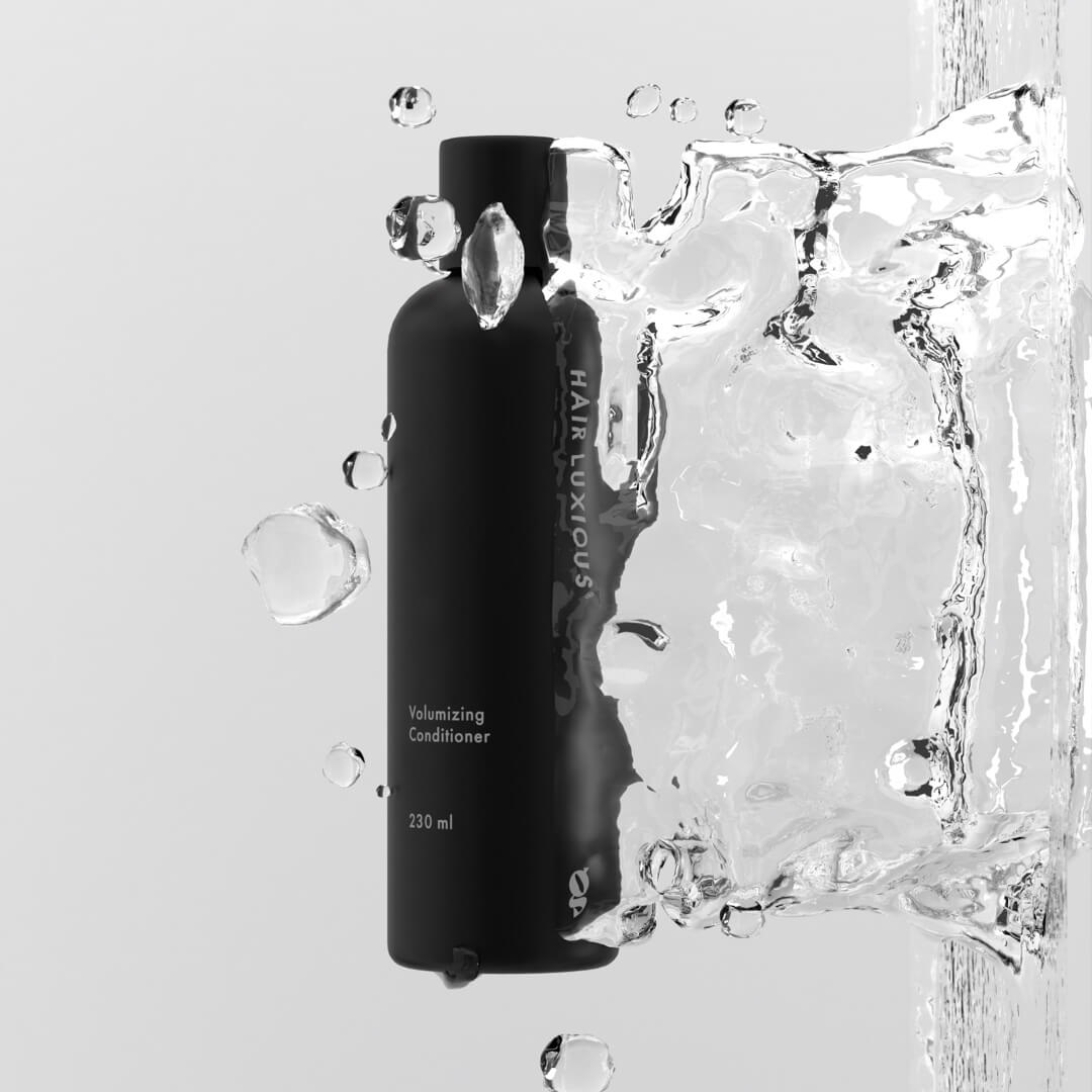 Hair Luxious Volumizing Conditioner bottle surrounded by splashing water